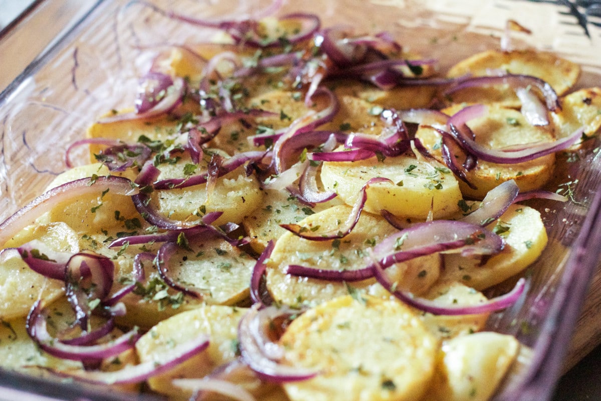 Top down view of baked potatoes in a clear dish