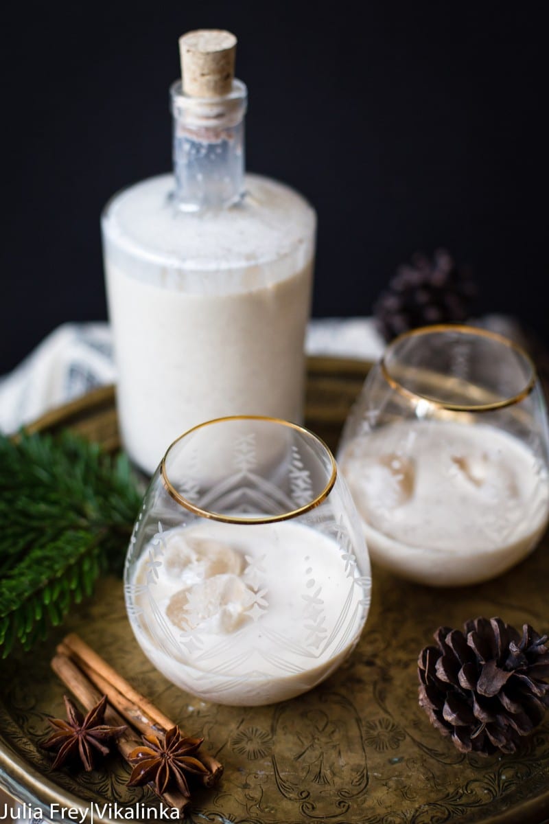 bottle of eggnog with two glasses