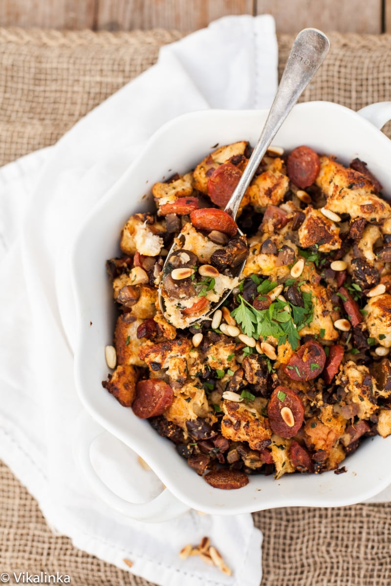 Top down of stuffing with serving spoon in white dish