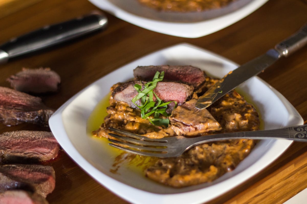 Action shot of steak being cut on a plate