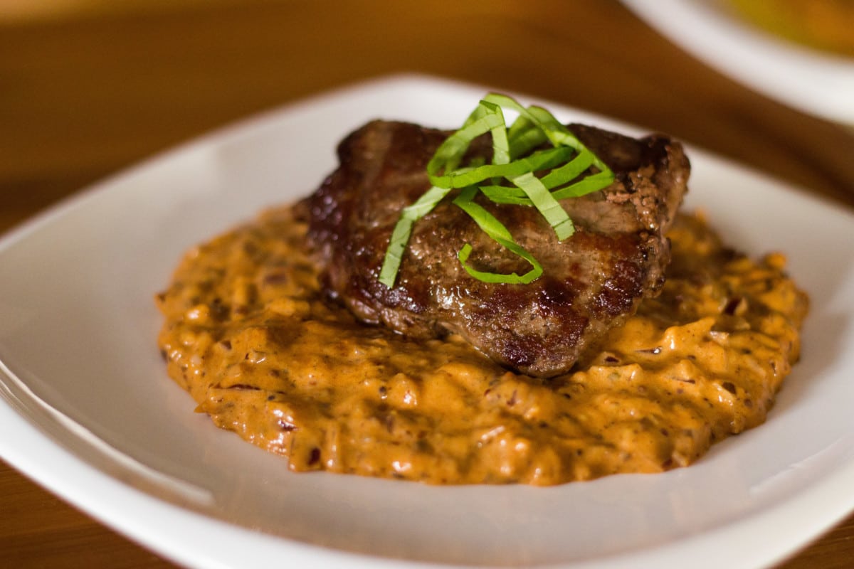 Close up of steak diane on white plate