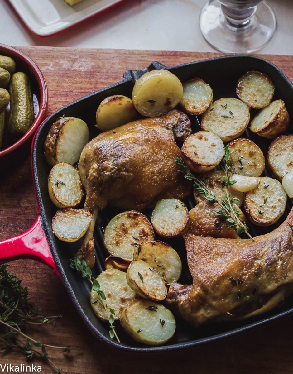 Top down of cooked duck and potatoes in a pan