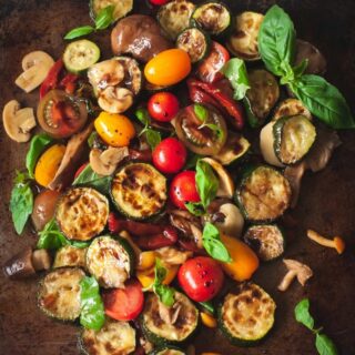 warm zucchini salad with cherry tomatoes, peppers and mushrooms