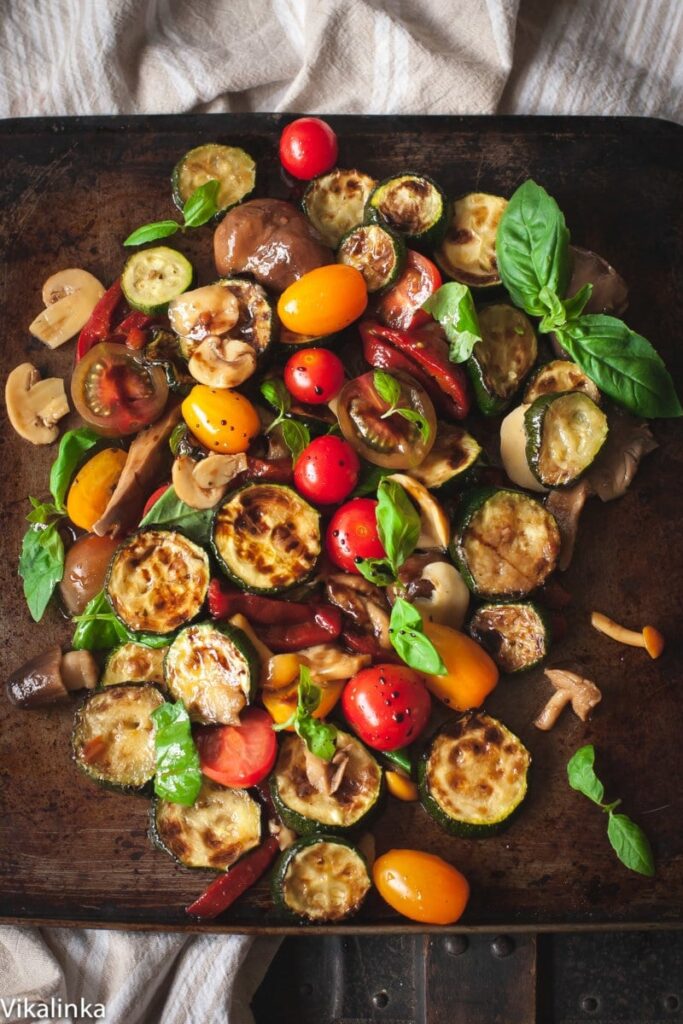 warm zucchini salad with cherry tomatoes, peppers and mushrooms