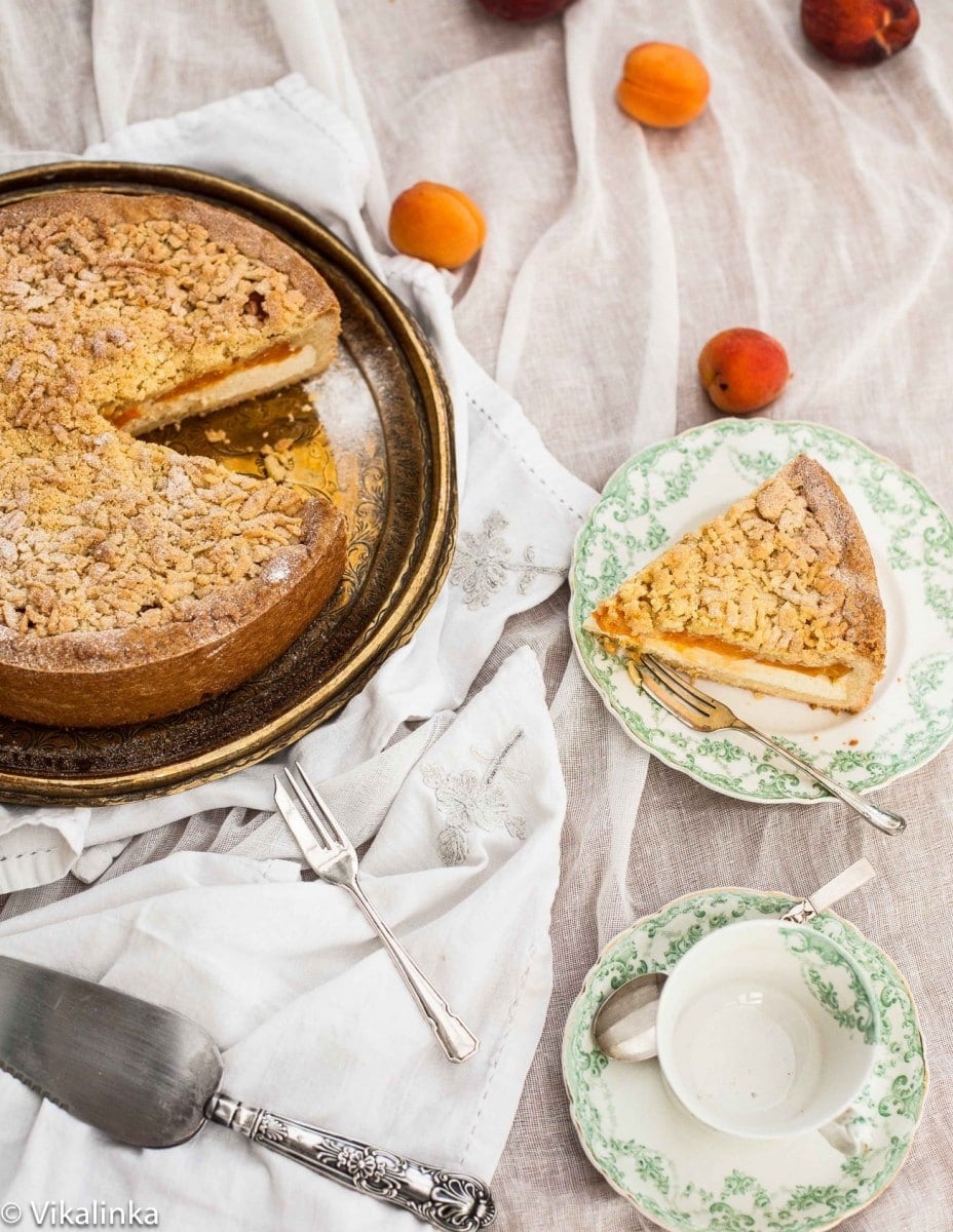 Slice of apricot cheesecake next to whole cake
