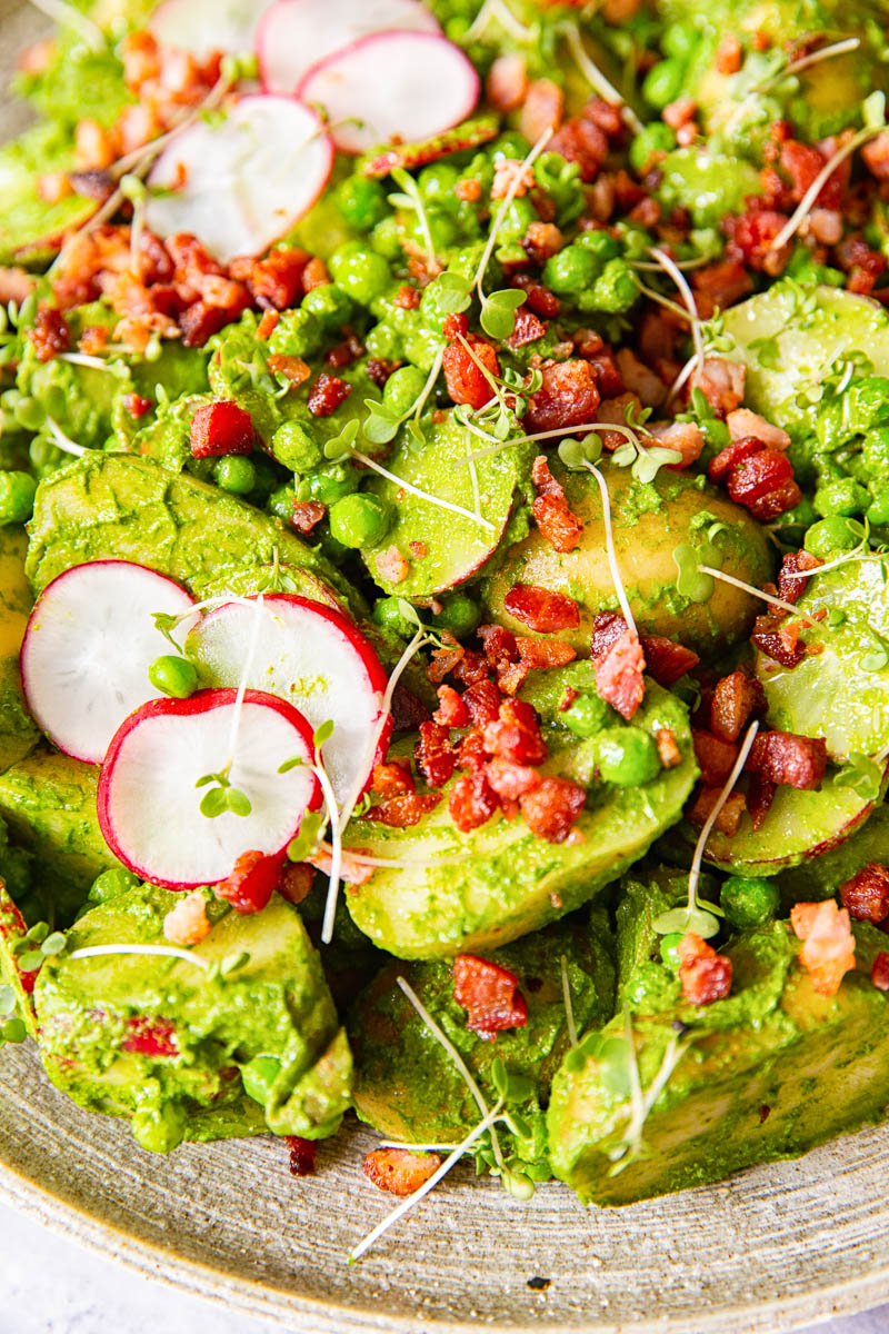 Pesto Potato Salad with sliced radishes and bacon bits. 