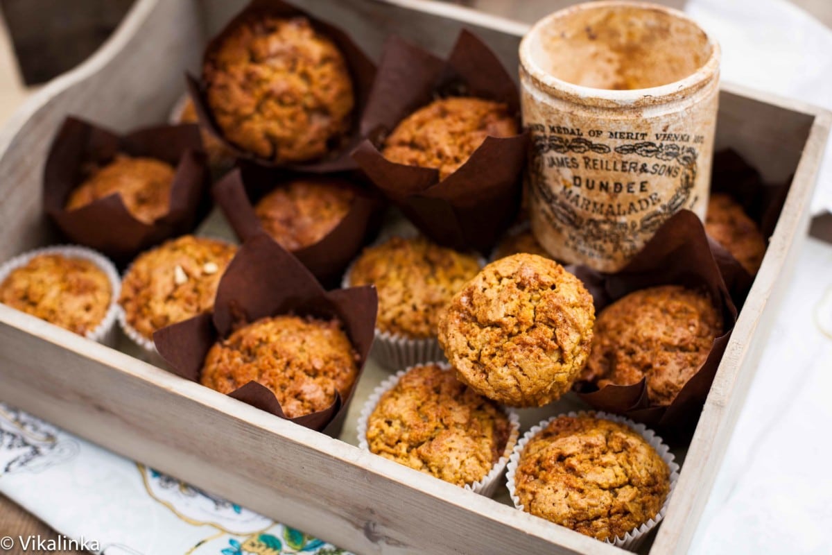 Multiple toffee pumpkin muffins in wooden box with jar of toffee