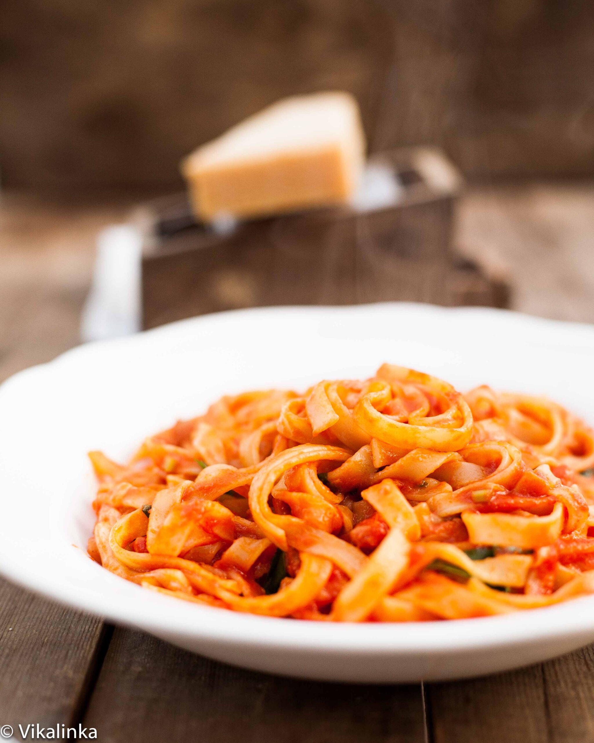 fettuccine with tomato sauce in a white bowl