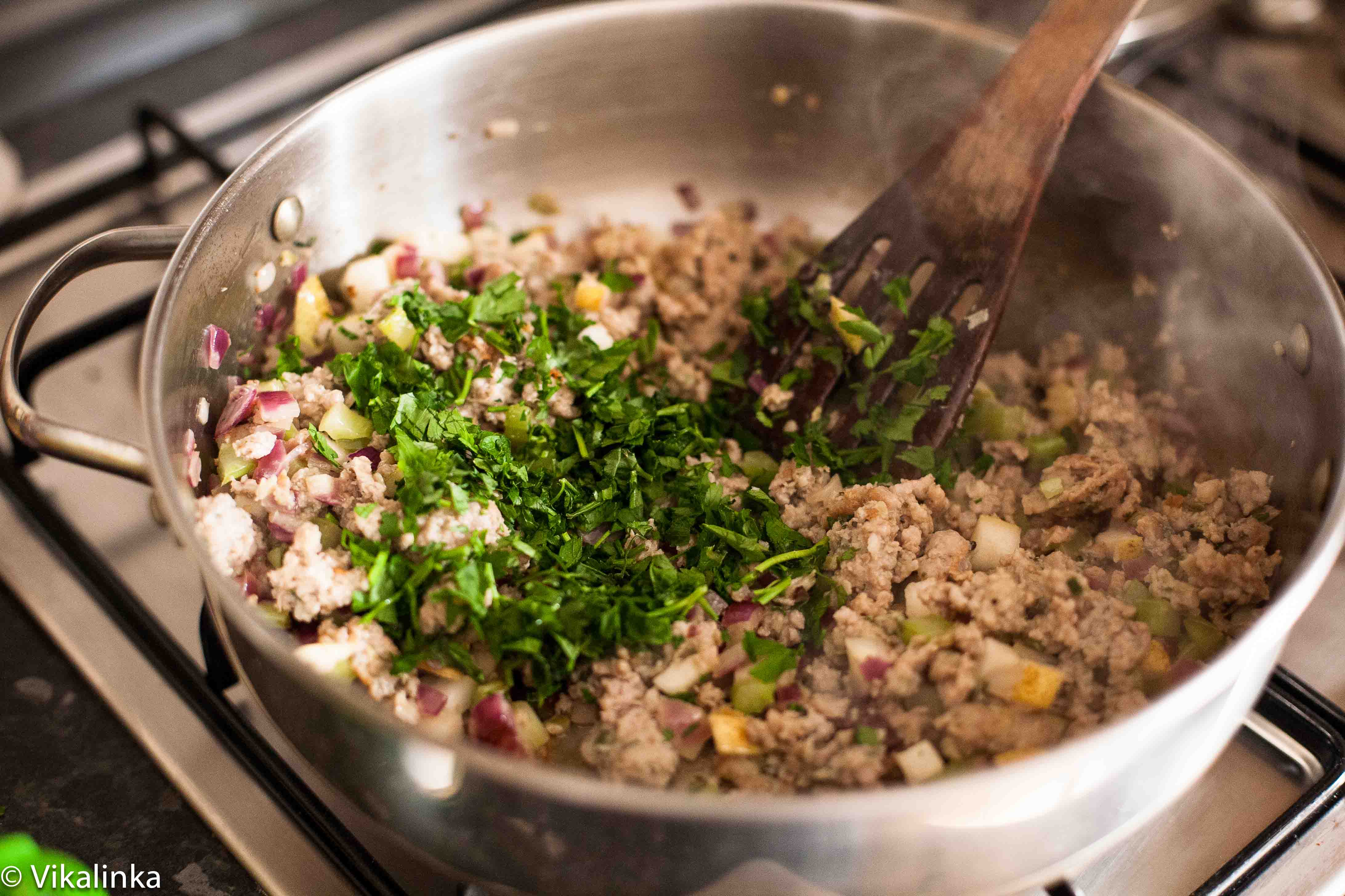 sausage and fresh herbs in frying pan
