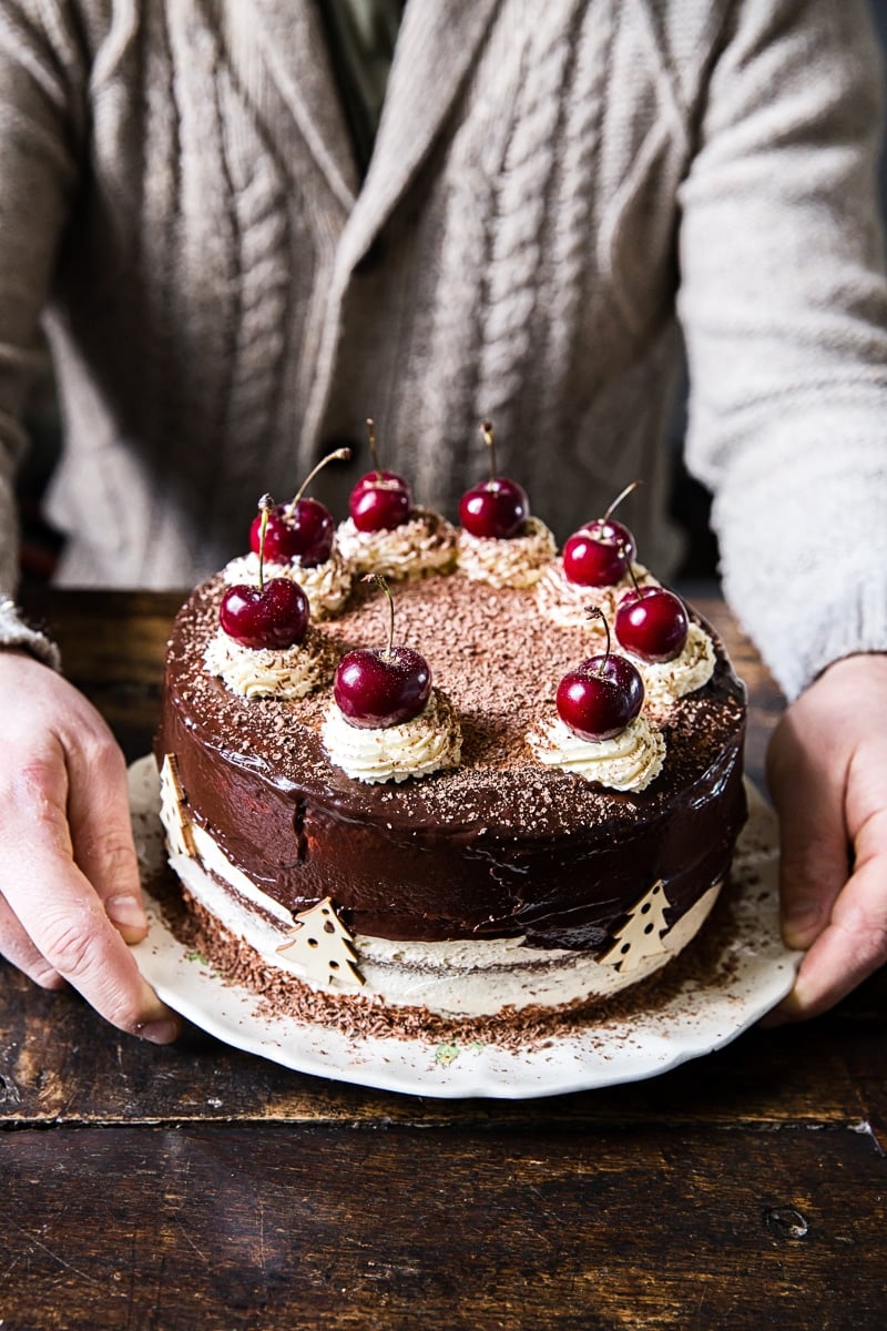 man holding chocolate cake 