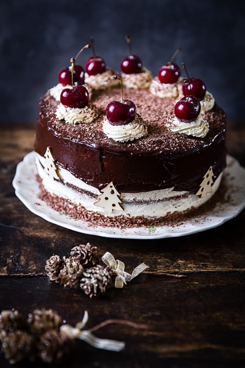 Black Forest Gateau in the background, pinecones in the foreground