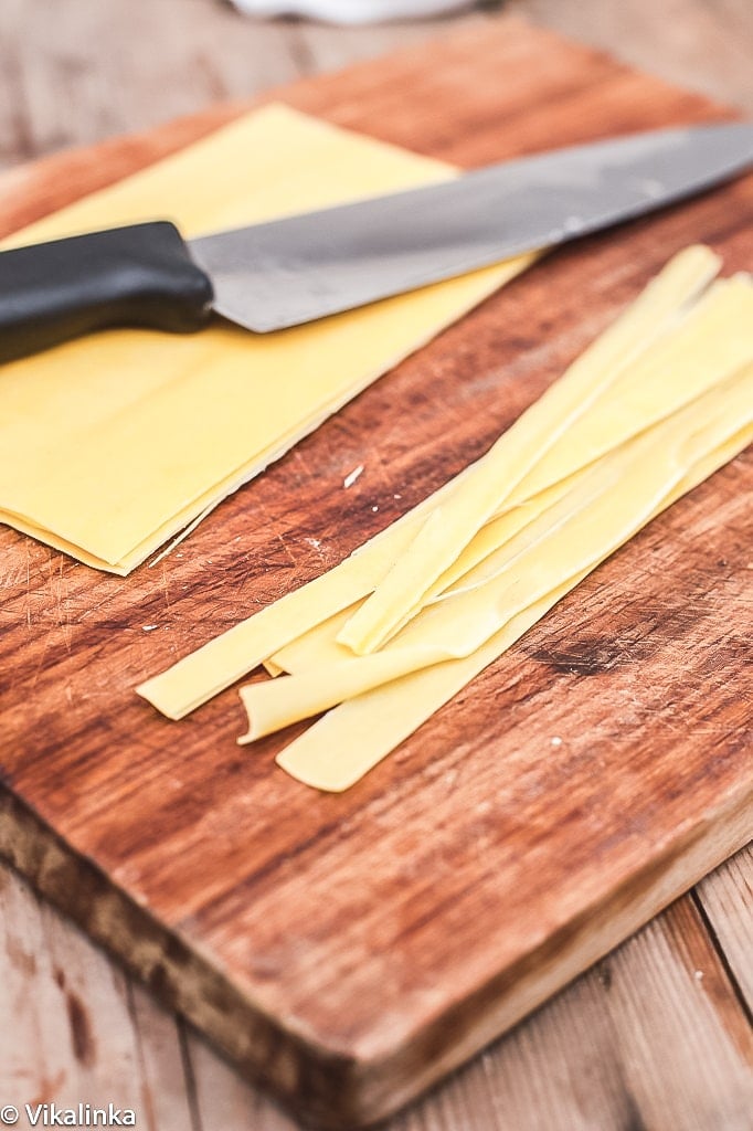 close up of pasta sheets being cut