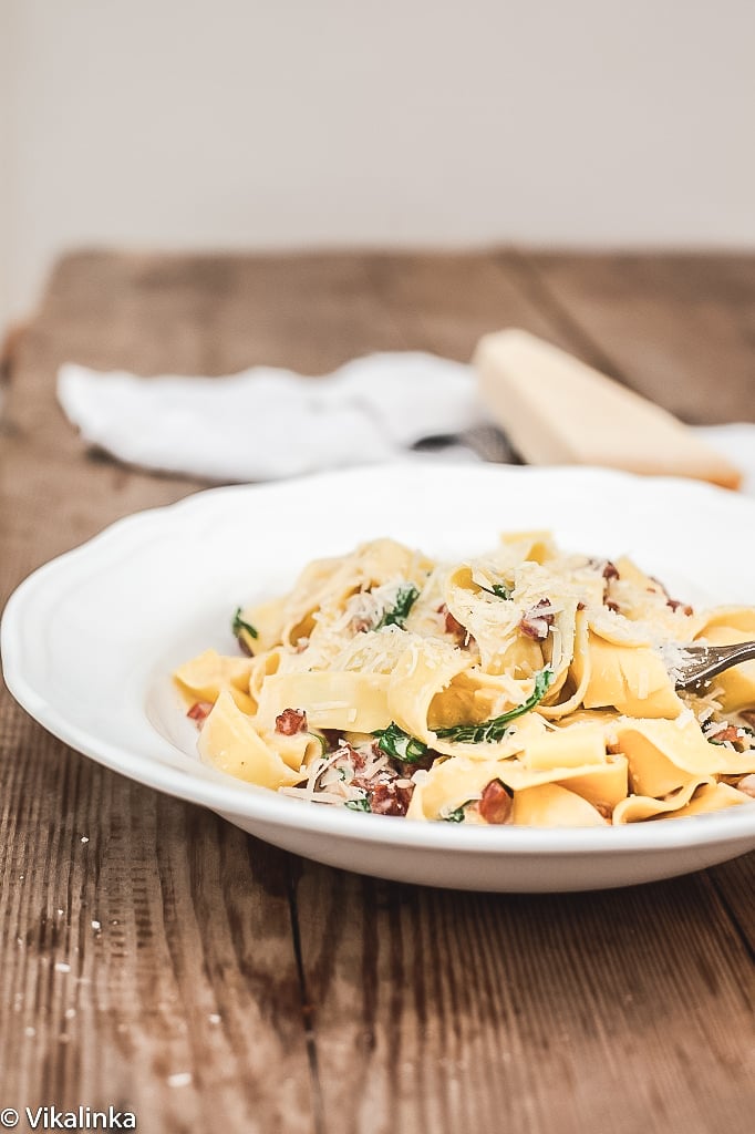 side shot of Pappardelle Carbonara with Arugula on plate