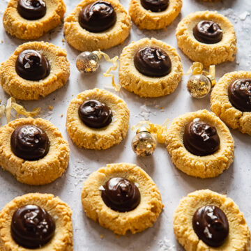 thumbprint cookies with chocolate on light background