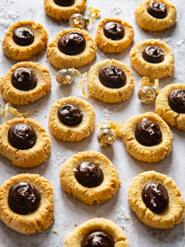thumbprint cookies with chocolate on light background