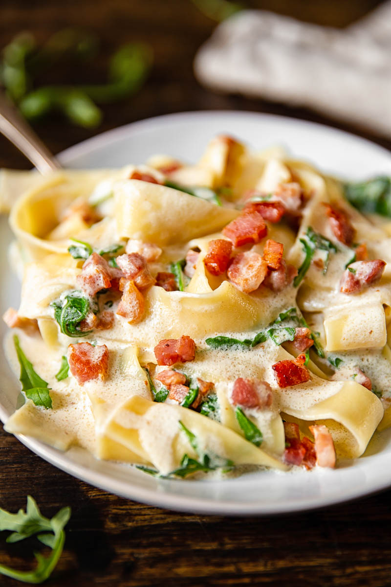 close up of Pappardelle Carbonara with Arugula