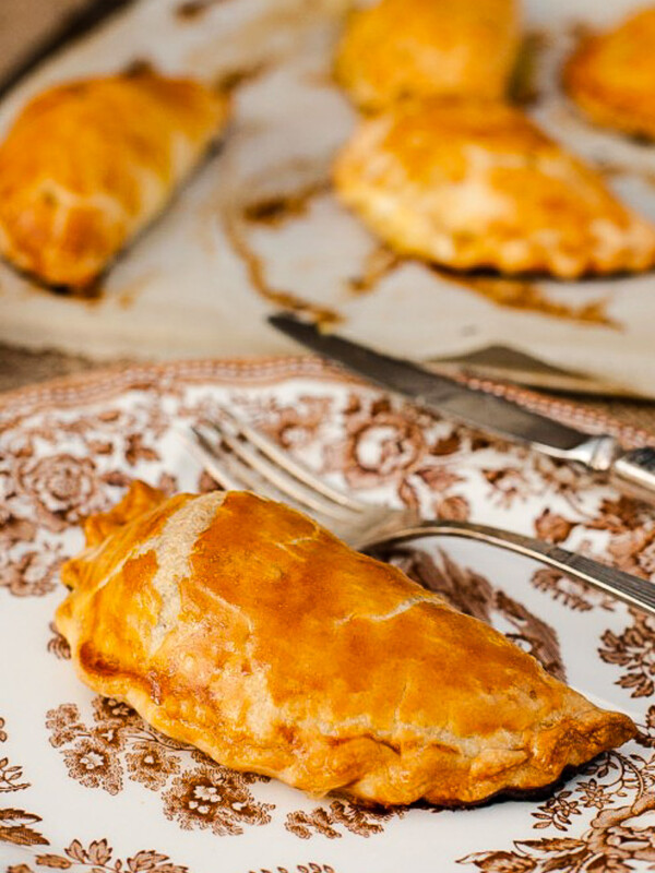 Cornish pasty on a white plate with brown design