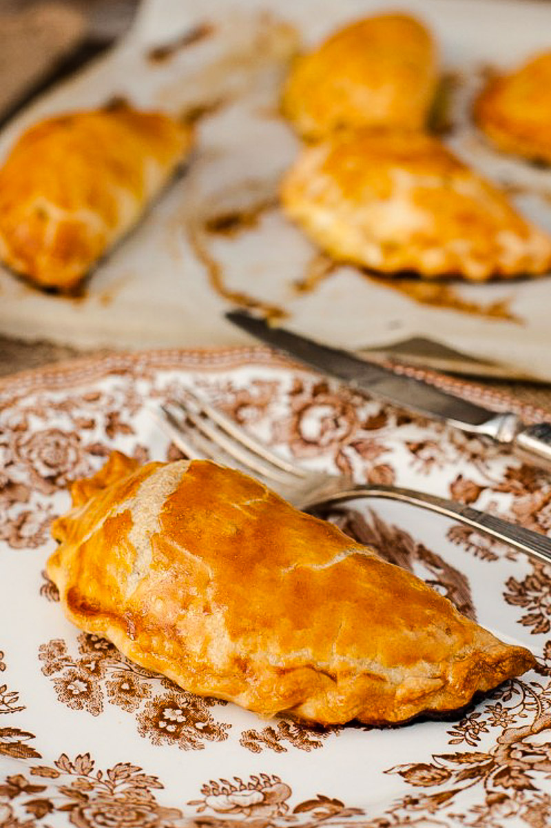 Cornish pasty on a white plate with brown design