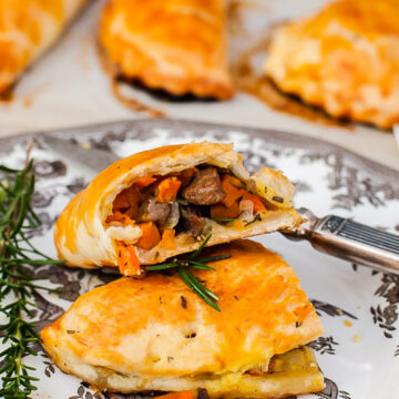 Cornish pasty broken into two on a plate