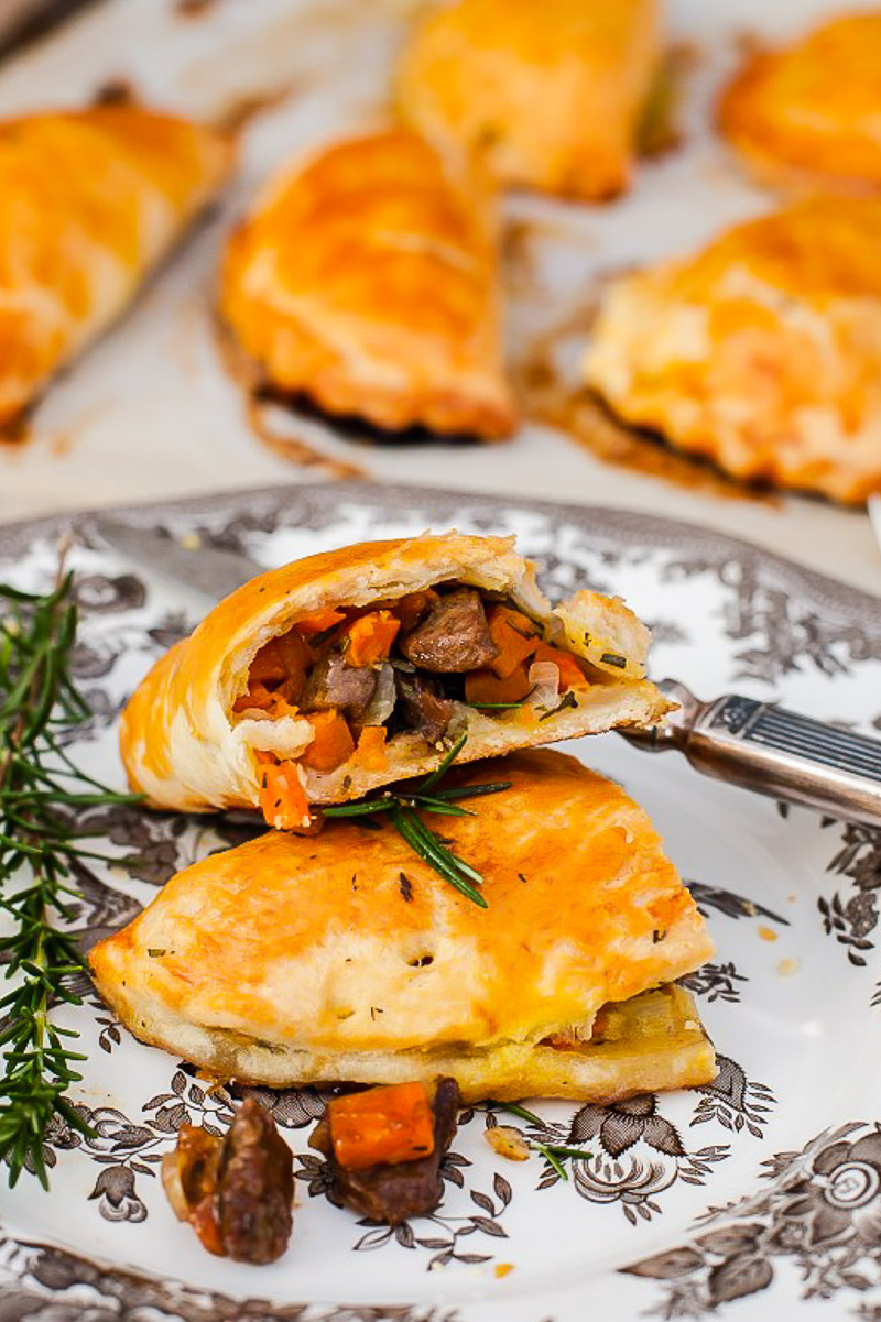 Cornish pasty broken into two on a plate