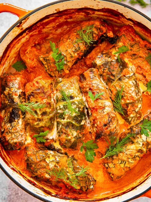 cabbage rolls in creamy tomato sauce in orange pot