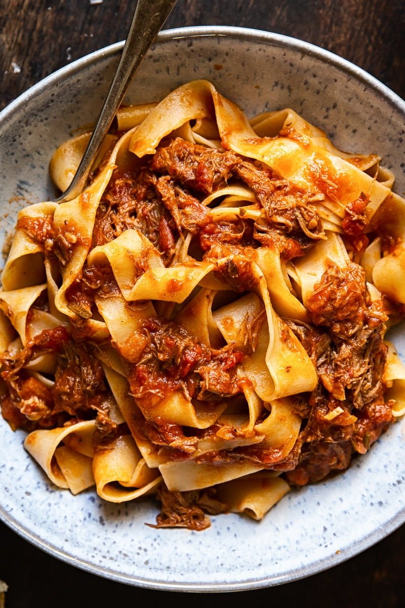 Top down of a bowl of Rustic Italian Beef Ragu with a fork