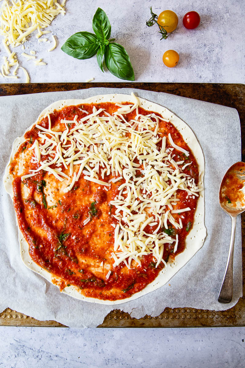 the process of making puff pastry pizza on a cutting board