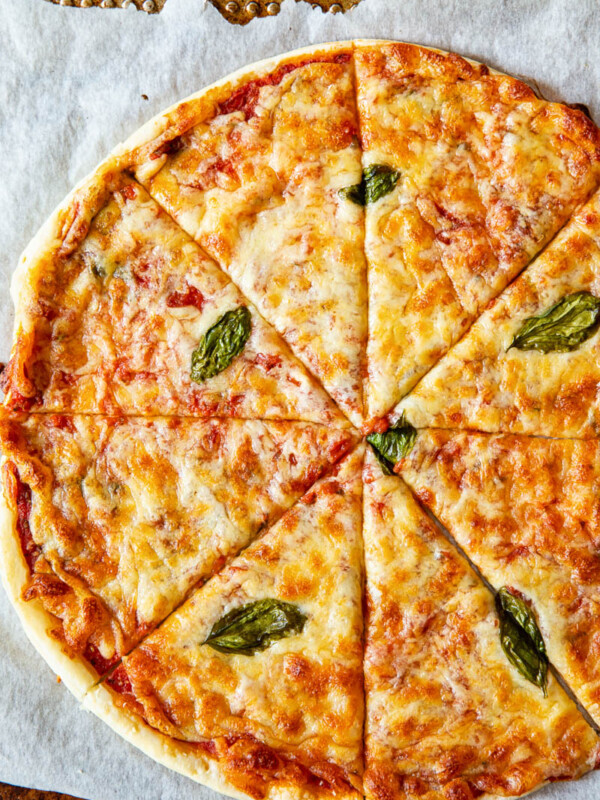 Top down view of puff pastry pizza margherita on a baking tray