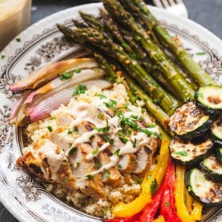 Mediterranean couscous bowl in small dish showing spread of ingredients