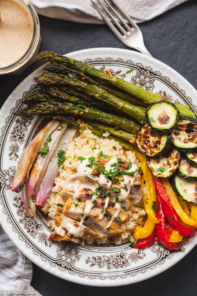 Top down view of couscous bowl showing roasted vegetables and Moroccan chicken