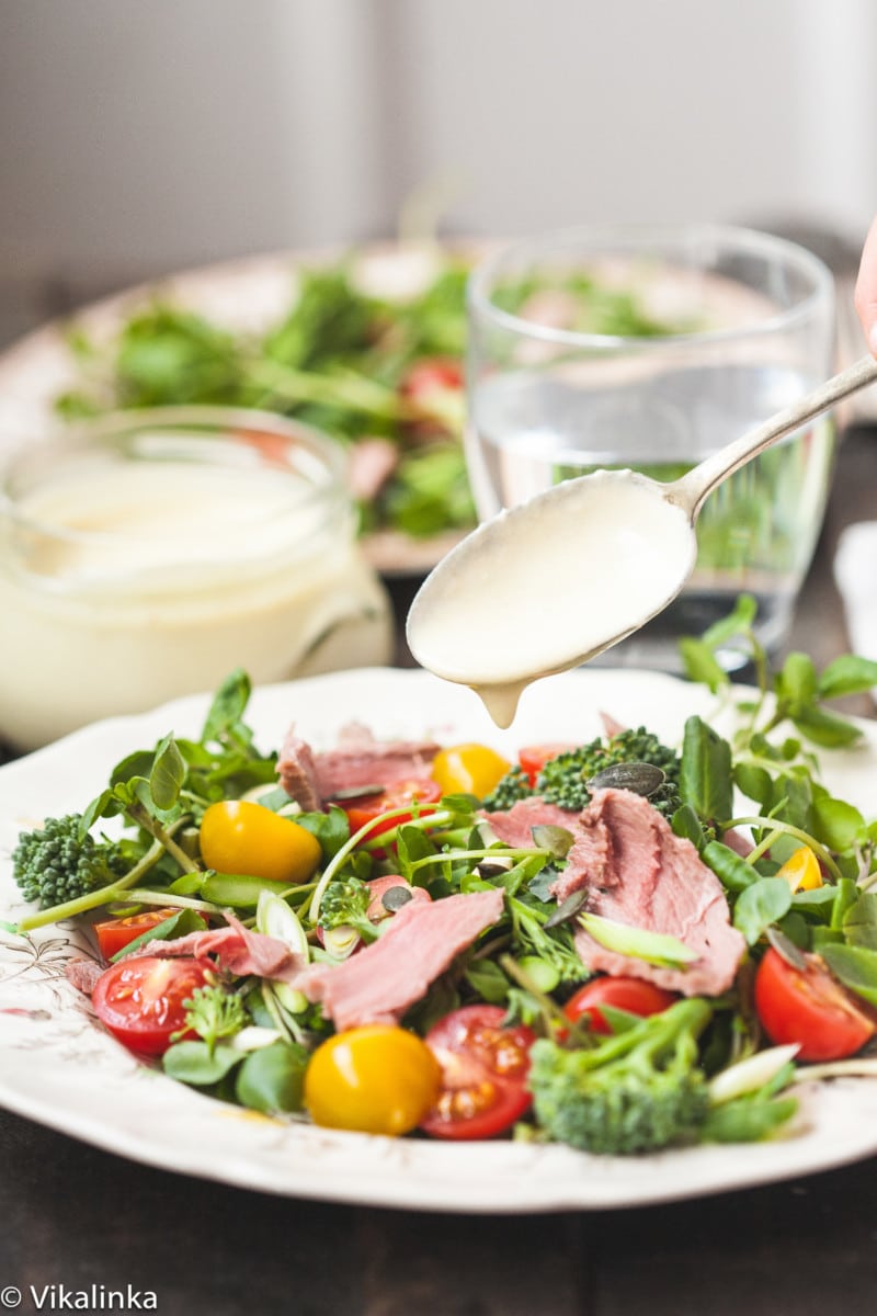 watercress salad with roast beef on a plate