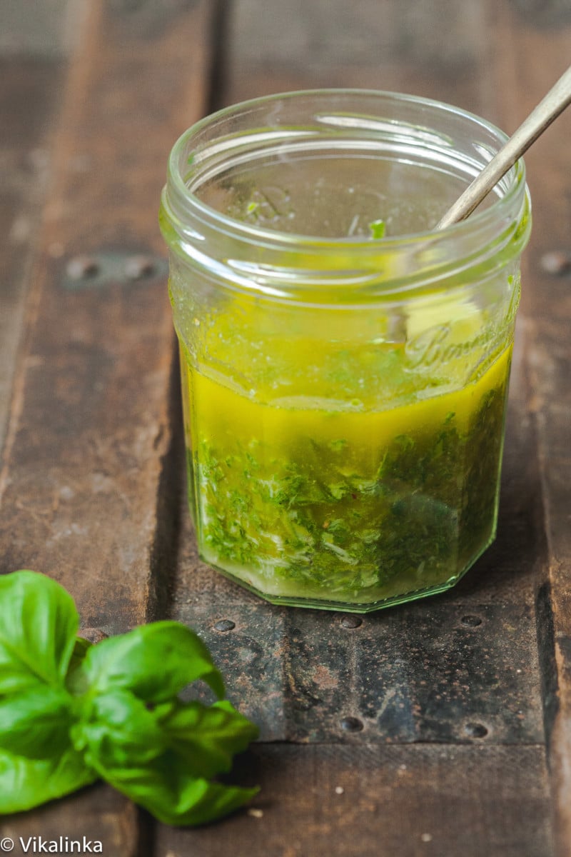 basil vinaigrette in mason jar with a spoon in the jar