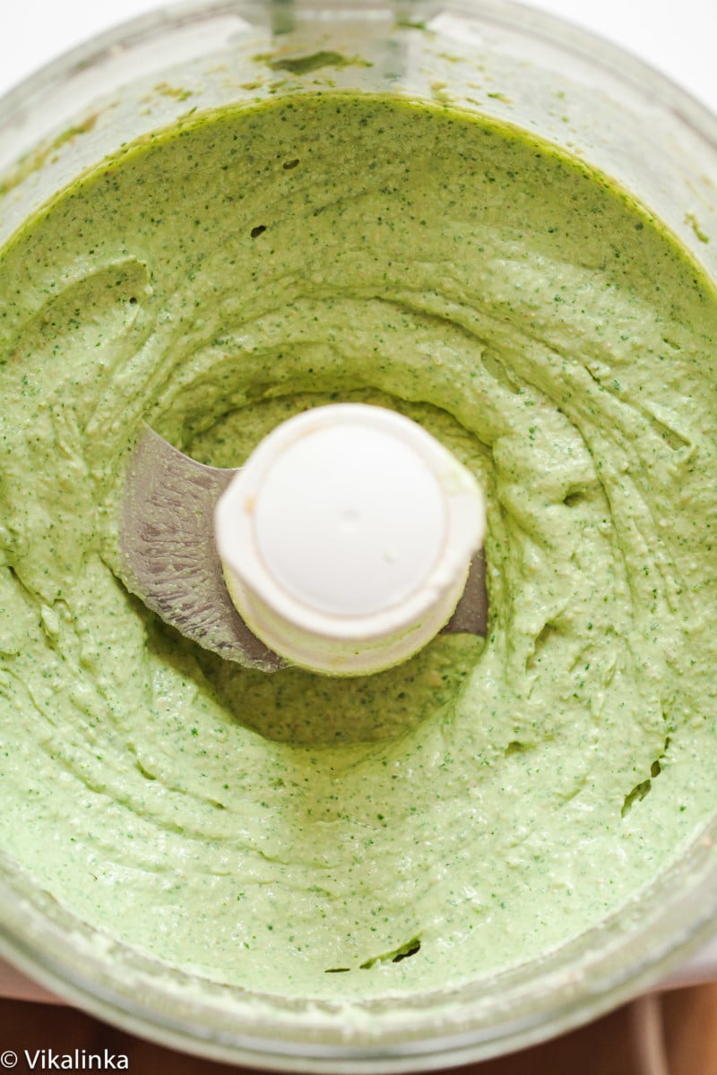 Top down view of cilantro and walnut dip in a blender