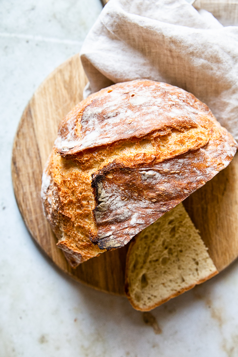 Loaf of Dutch Oven Bread on a wooden cutting board