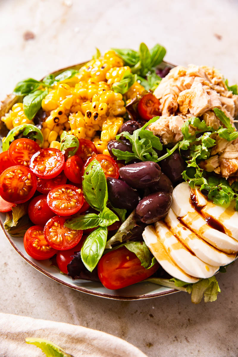 Italian Salad with cherry tomatoes, tuna, corn, olives and fresh mozzarella