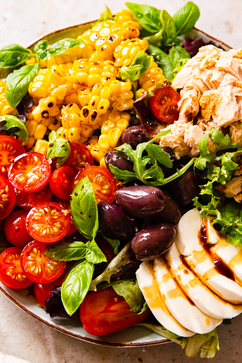 Italian Salad with cherry tomatoes, tuna, corn, olives and fresh mozzarella