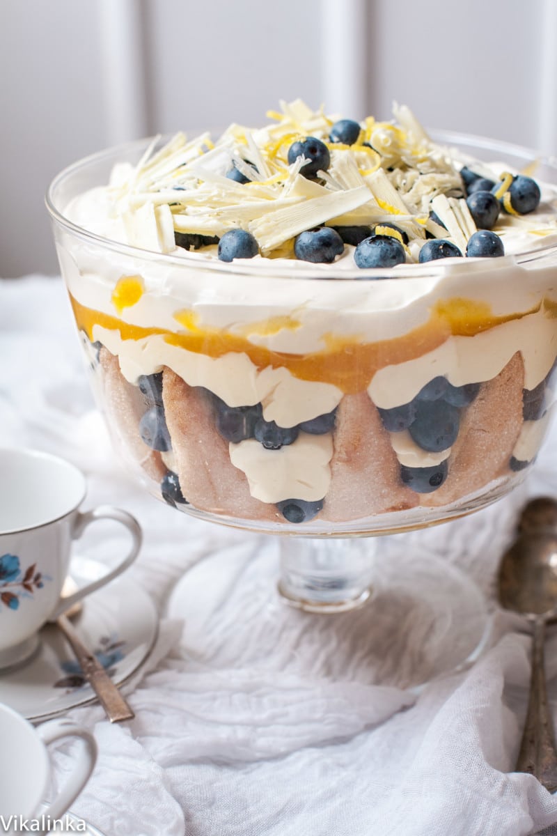 Blueberry Lemon Trifle on a table covered with white cloth and a white and blue teacup