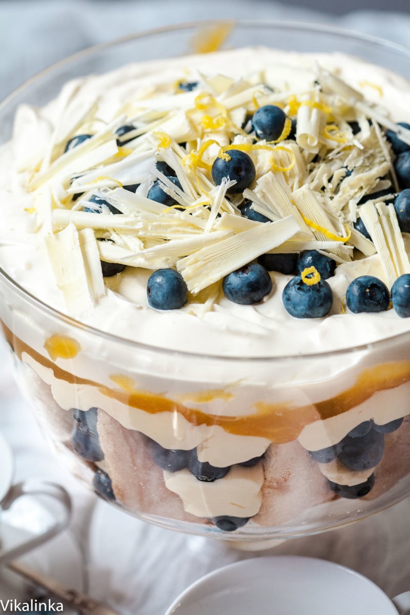 trifle topped with blueberries and shaved white chocolate