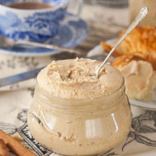 cashew butter in a glass jar with a spoon in it