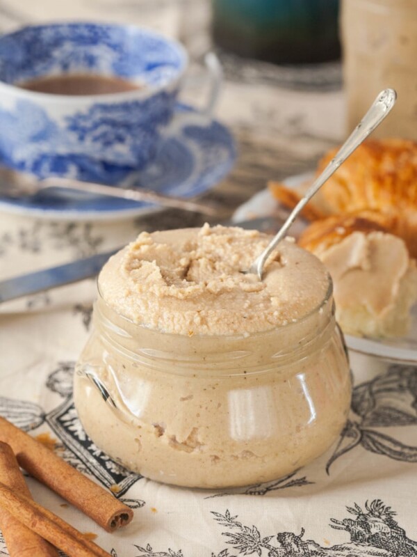 cashew butter in a glass jar with a spoon in it