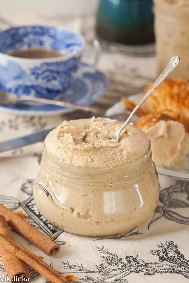 cashew butter in a glass jar with a spoon in it