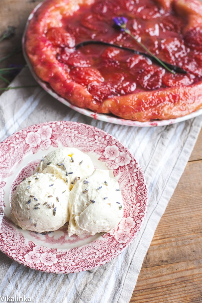 3 scoops of whipped cream sprinkled with lavender, tarte tatin in the background