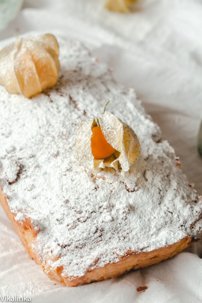 top down view of a pound cake dusted with icing sugar