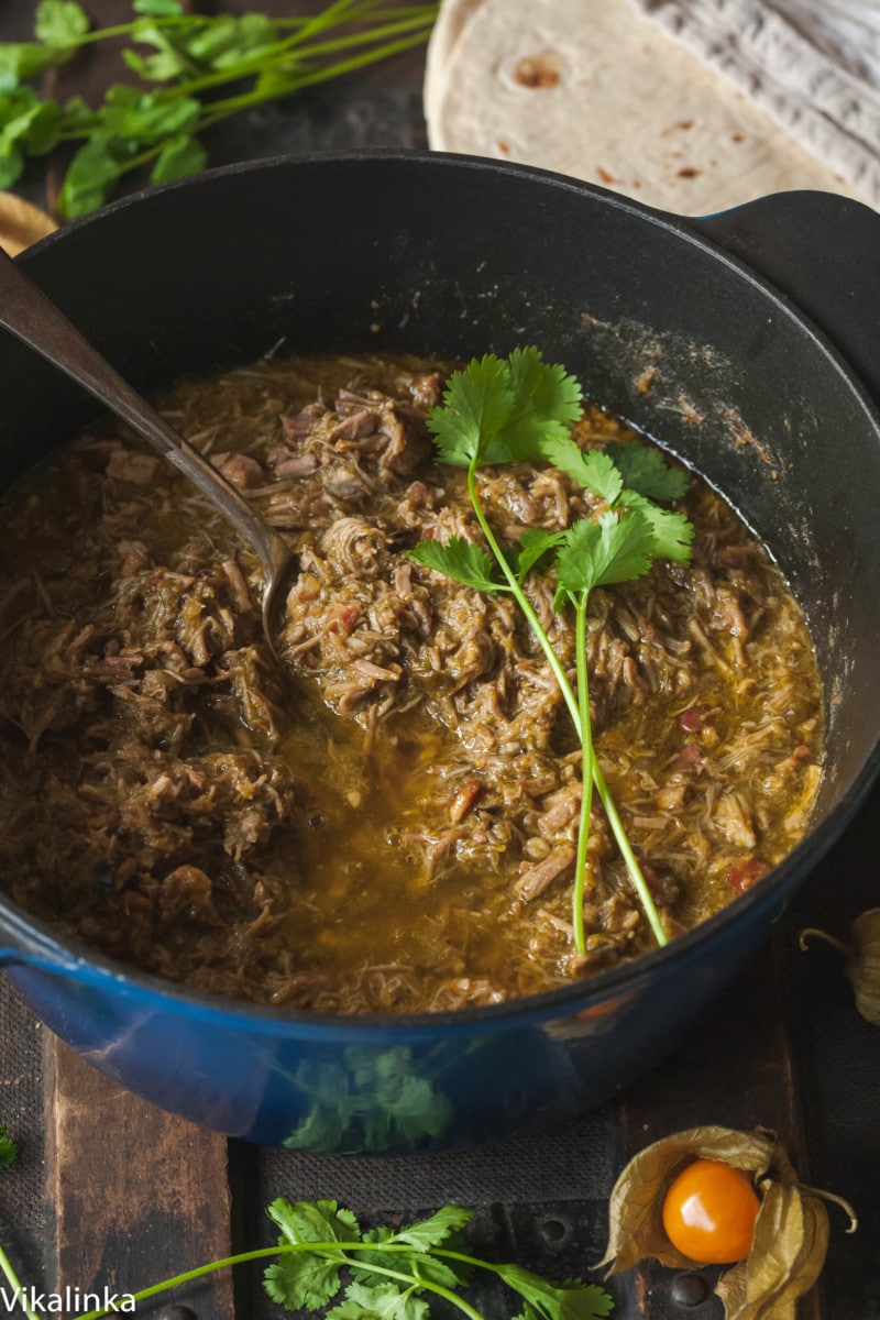 Green chili in a blue Dutch Oven