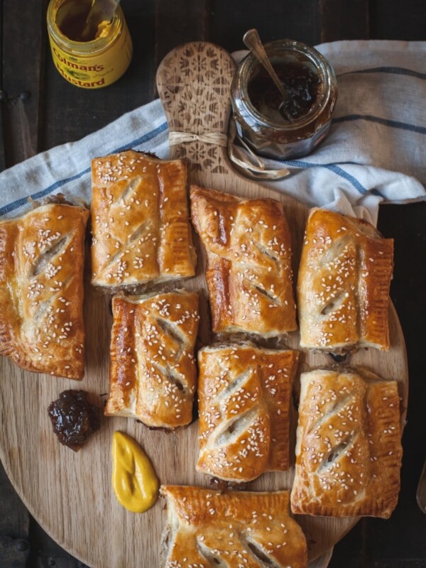 Top down shot of sausage rolls on a board