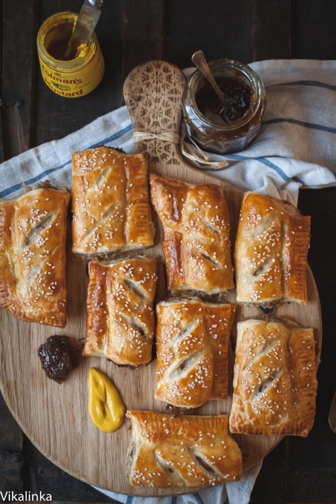 Top down shot of sausage rolls on a board