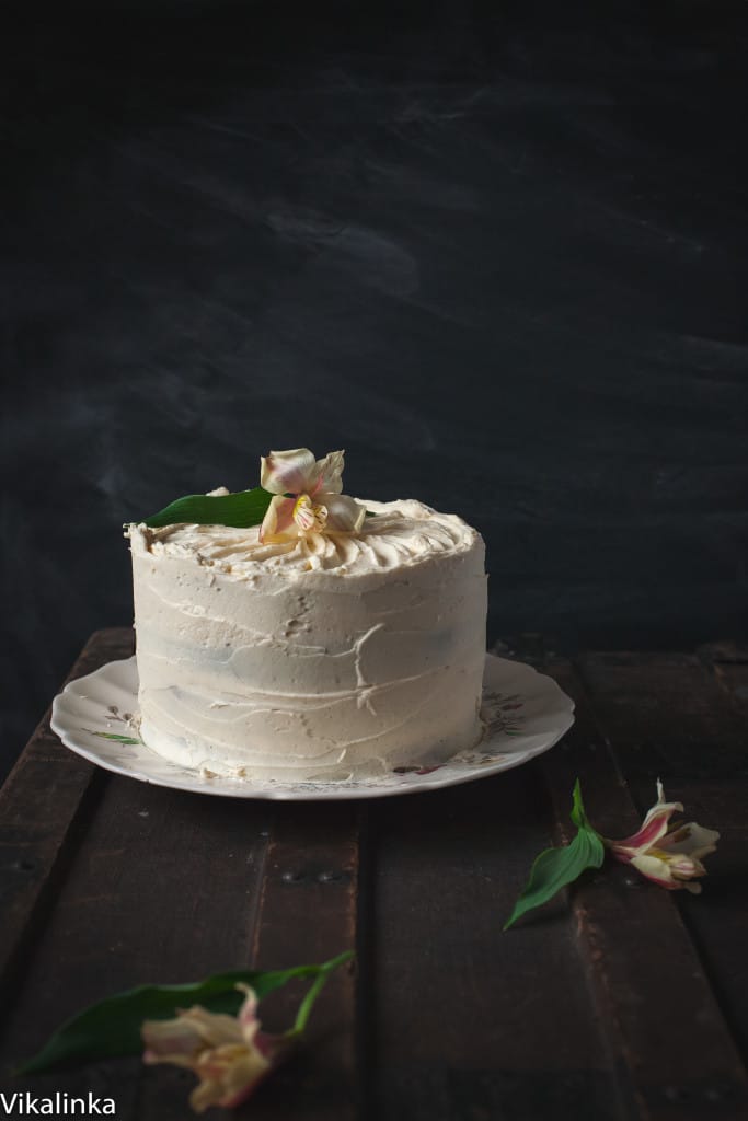 Side view of the pumpkin and chocolate cake against a dark background