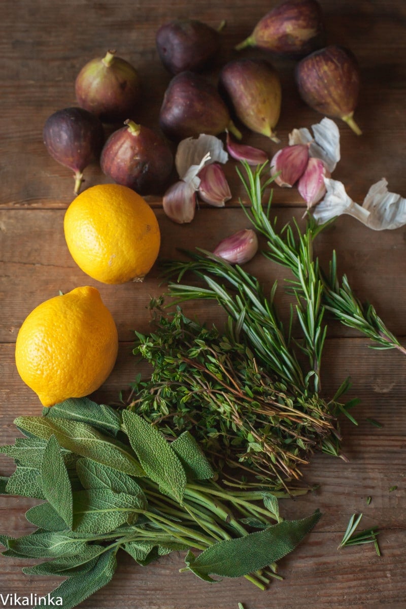a selection of herbs, garlic, lemons and fresh figs
