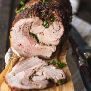 Side view of sliced pork on cutting board