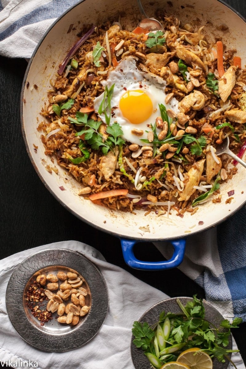 TNasi Goreng in a pan next to dish of peanuts